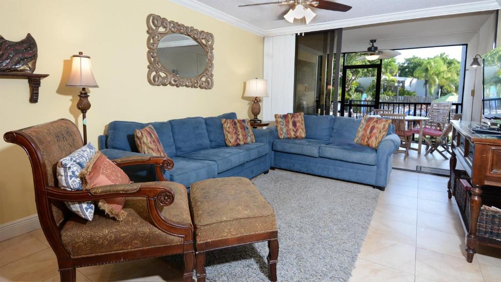 a living room with a blue couch and chairs at B105 Moon Bay in Key Largo