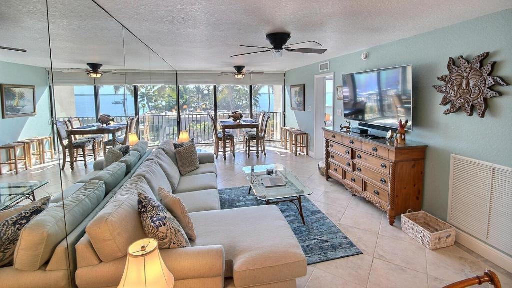 a living room with a large couch and a television at B307 Moon Bay in Villa Verde