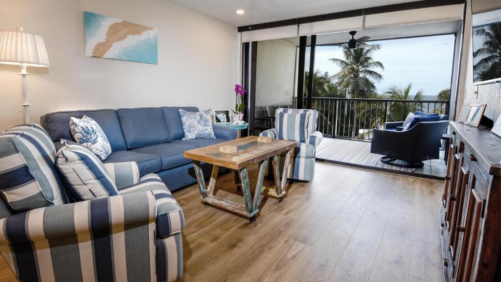 a living room with a blue couch and a table at A409 Moon Bay in Key Largo