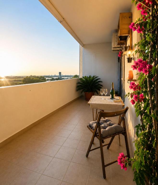 a balcony with a table and a view of the city at Gate 10 - Bari Airport Apartment in Bari