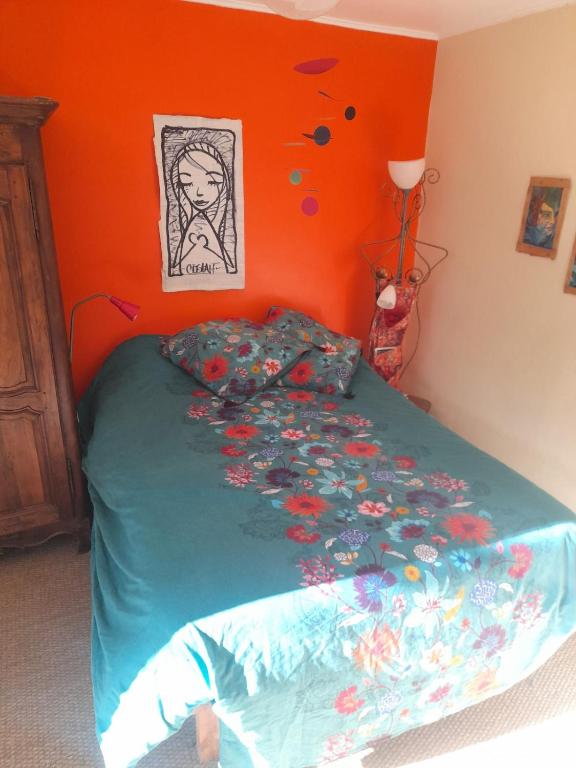 a bedroom with a bed with a drawing on the wall at Chez Flo in Lamastre