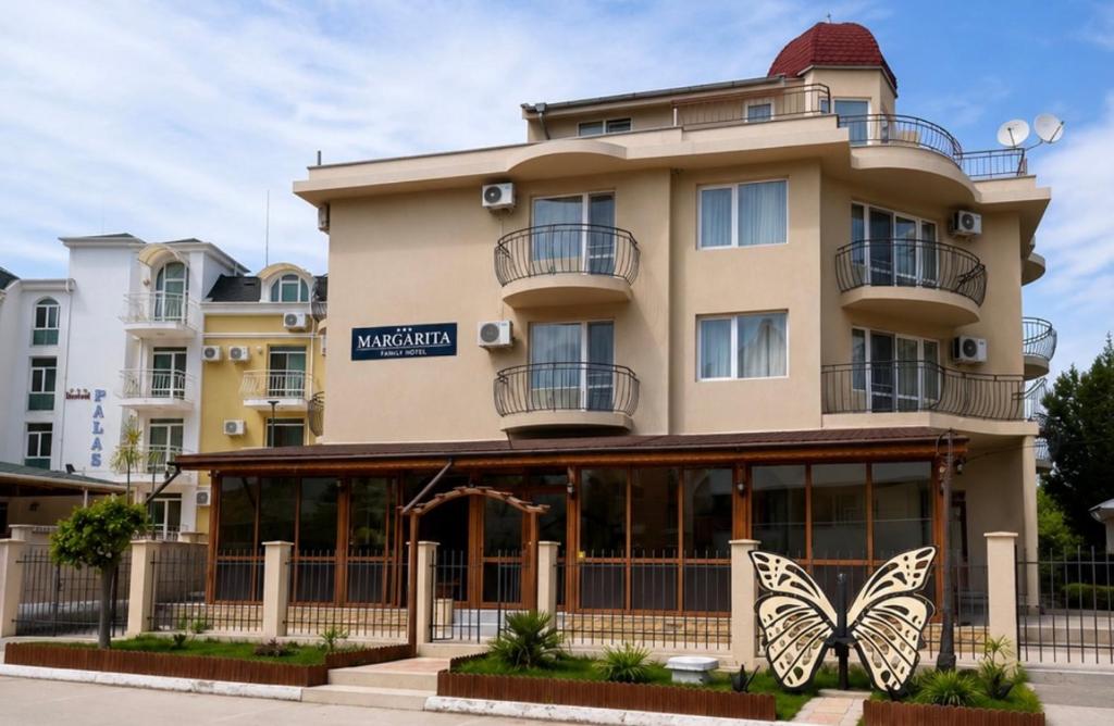 a building with a butterfly on the front of it at Hotel Margarita in Kranevo