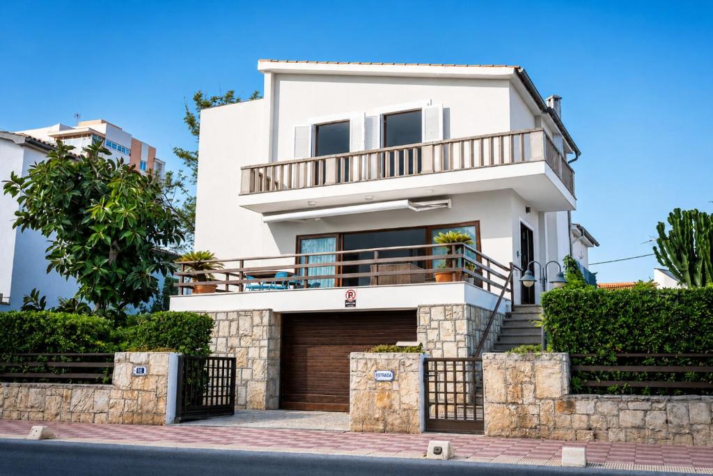a white house with a balcony at Villa Marbella by Slow Villas in El Arenal