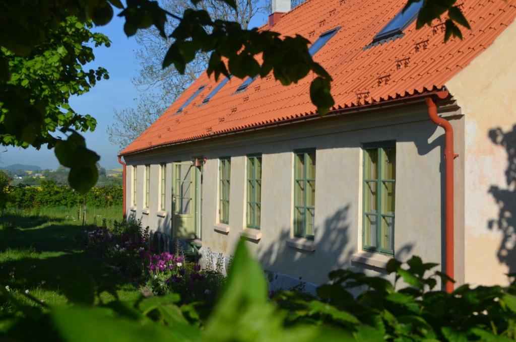 an old house with a red roof at Stylish Swedish farmhouse in Borrby