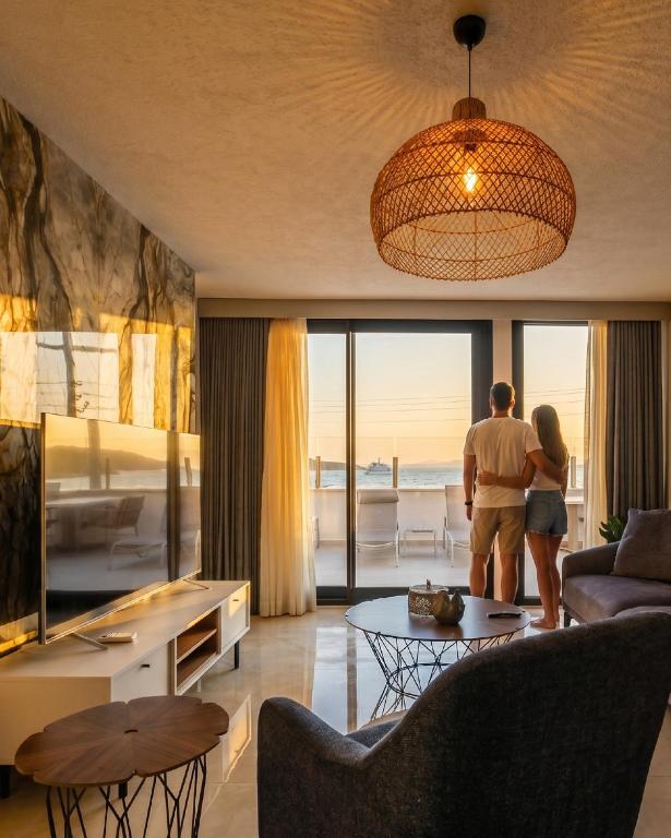 a man and a woman standing in a living room at Babana Hotel in Golturkbuku