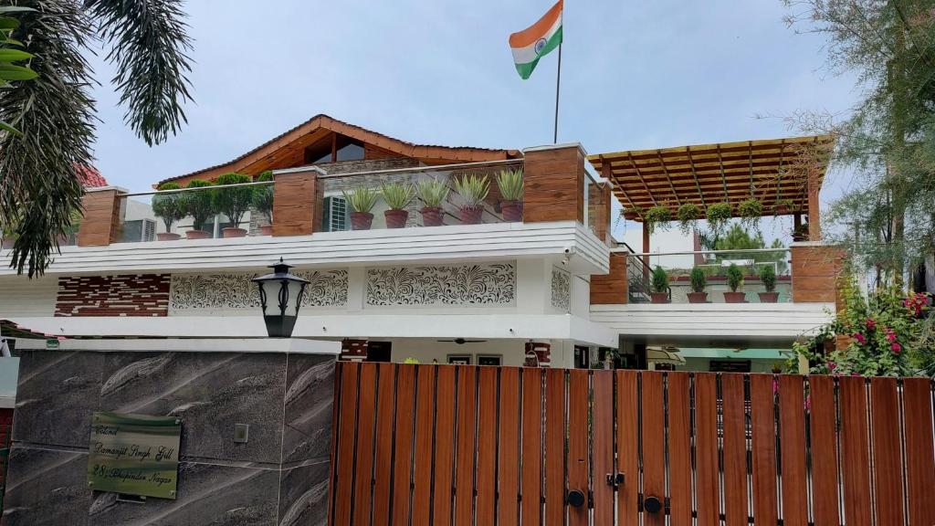 a house with a flag on top of it at Ashiana in Patiāla