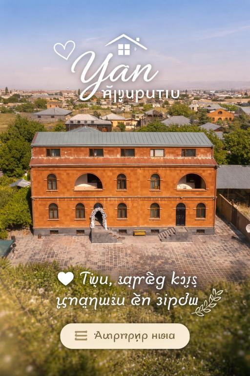 a picture of a large brick building with the words yan at Yan Guest House in Gyumri