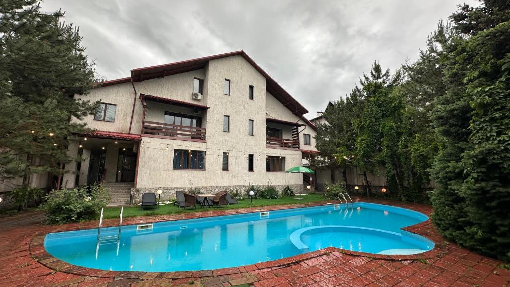 a house with a swimming pool in front of it at Gatsby Ortosay in Orto-Say