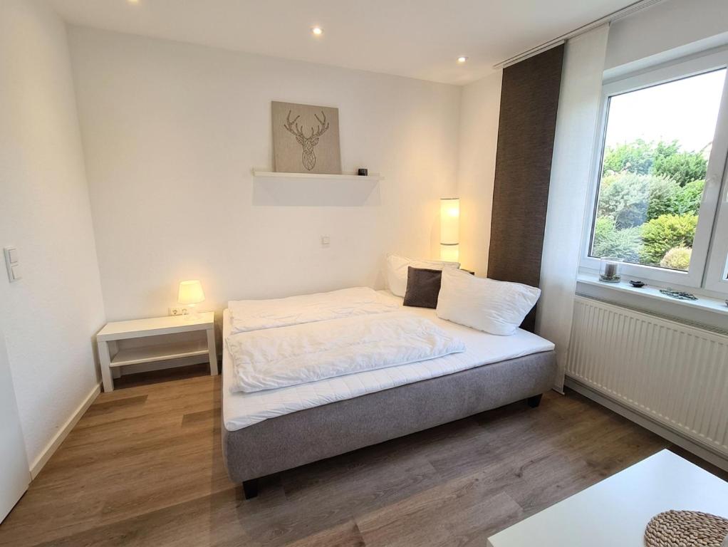 a small bedroom with a bed and a window at Apartment Jan im Dangaster Nest in Varel