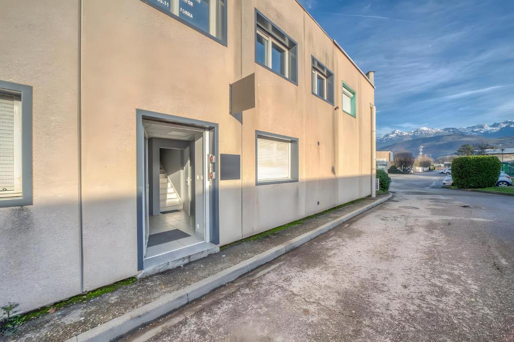 a building with an open door on the side of it at Campus & Work in Saint-Martin-dʼHères