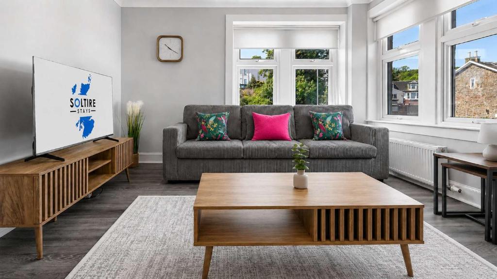 a living room with a couch and a coffee table at Parkview Apartment in Rothesay