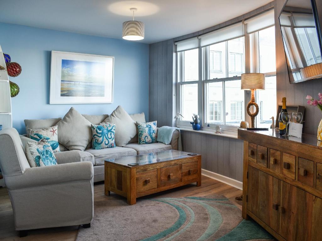 a living room with a couch and a coffee table at Seagulls Lookout in Weymouth