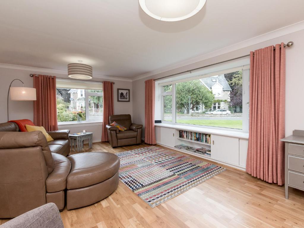 a living room with a couch and a chair at Sheeoch in Comrie
