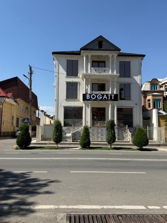 a building on the side of a street at Hotel Bogatt in Dushanbe
