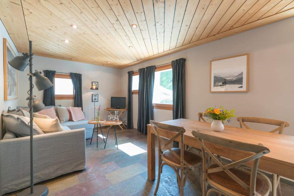 a living room with a table and a couch at Chesa Survial 4 in Sils Maria