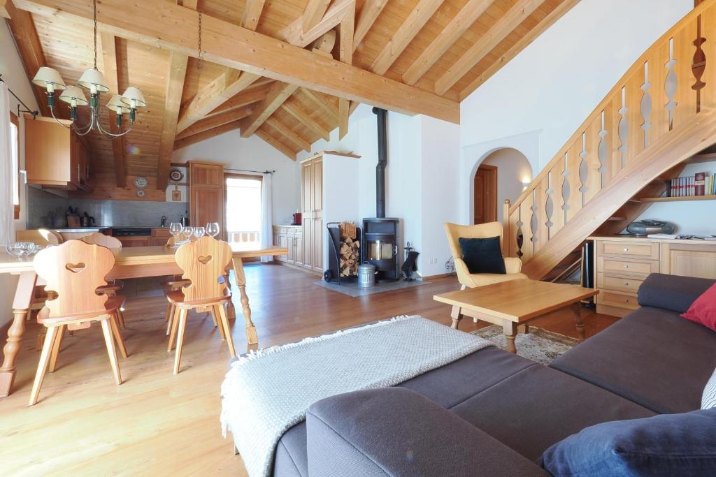 a living room with a couch and a table and a kitchen at Trais Fluors C3 in Maloja