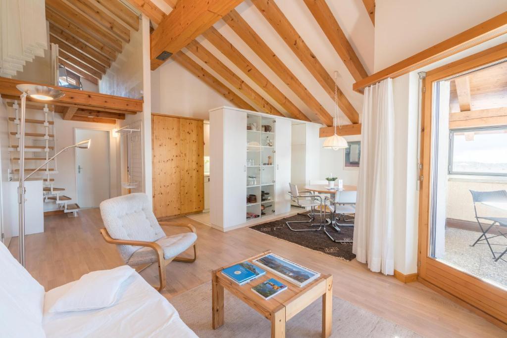 a living room with a couch and a table at Chesa Cravunera 29 in Sils Maria