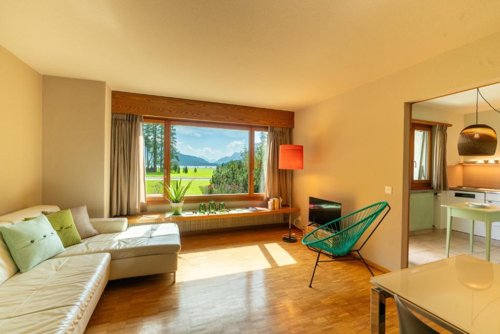 a living room with a couch and a table at Chesa Tscheppa 1 in Sils Baselgia