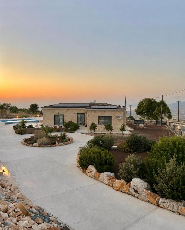 a building with a sunset in the background at Villa Terra Rosa in Kritou Terra