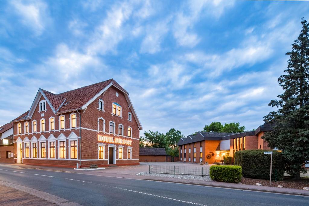 a large brick building on the side of a street at Hotel zur Post in Hemmingen
