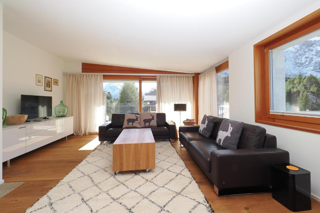 a living room with a couch and a table at Chesa Soldanella 9 in Maloja