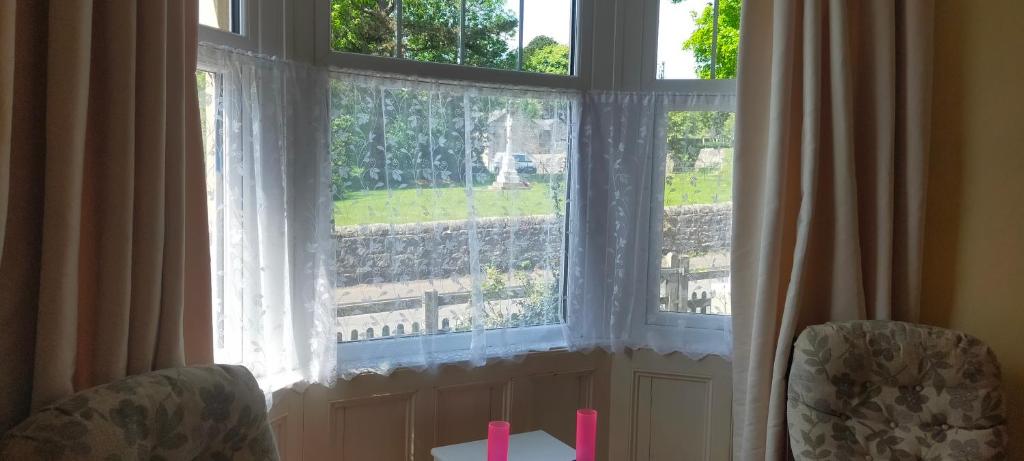 a large window with two chairs in front of it at Cenotaph View, Bardon Mill in Hexham
