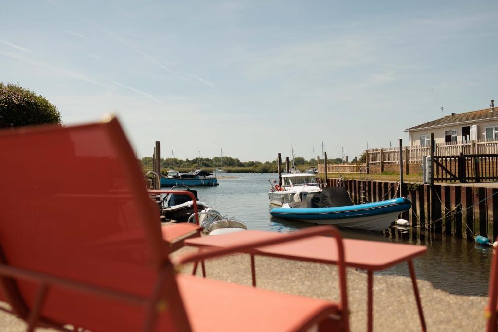 a group of boats are docked at a marina at Peaceful Riverside Family Retreat in Christchurch