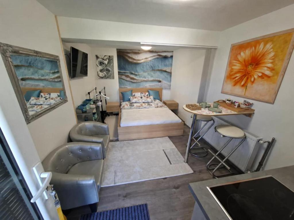 a bedroom with a bed and a table and chairs at Frix Balaton in Balatonalmádi