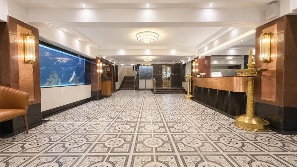 a hallway of a hotel with a tile floor at Hotel Mulki International in Mūlki