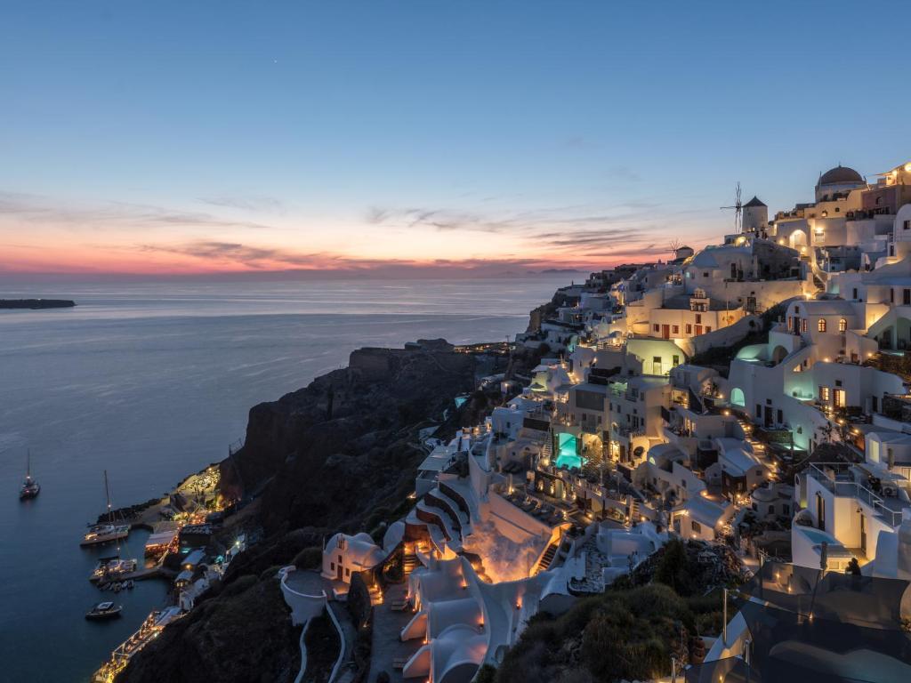 a view of the amalfi coast at night at Art Maisons Oia Castle in Oia