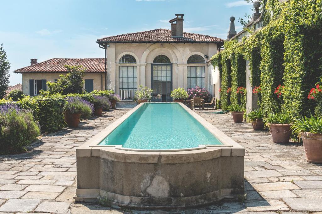 a swimming pool in front of a house at Villa La Limonera in Casciago