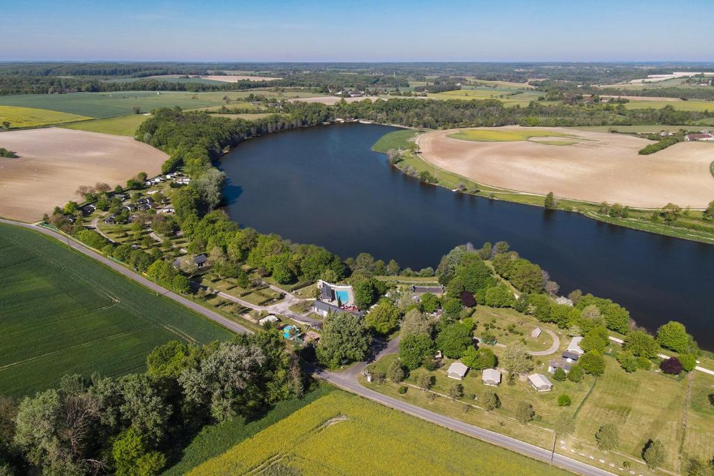 an aerial view of a lake and a farm at Camping les Coteaux du Lac in Chemillé-sur-Indrois