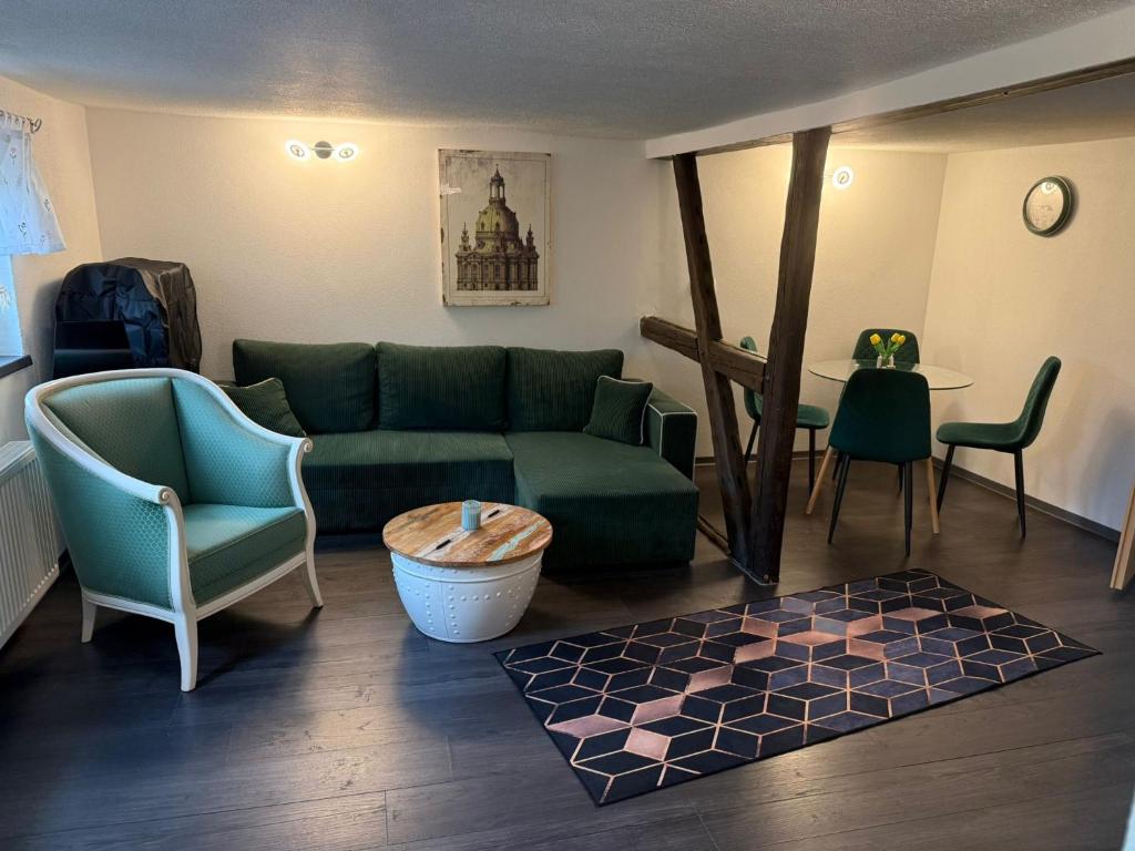 a living room with a couch and chairs and a table at Ferienwohnung Mutzelmann in Kurort Gohrisch