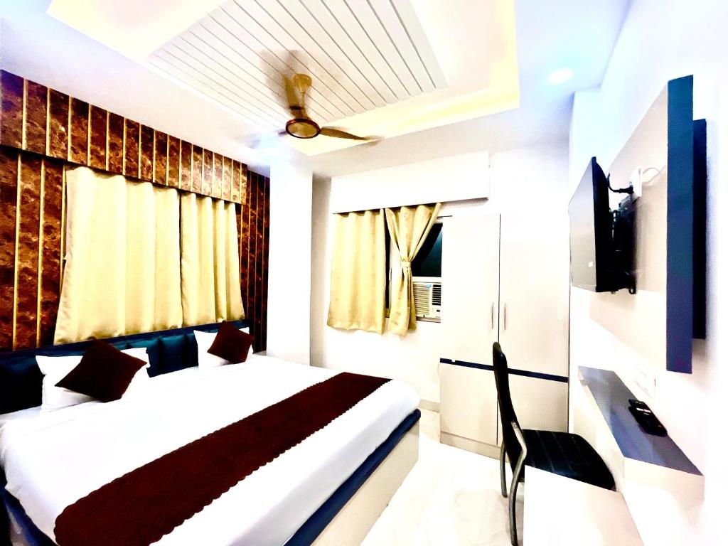 a hotel room with a bed and a tv at Shiv Dham Palace in Varanasi
