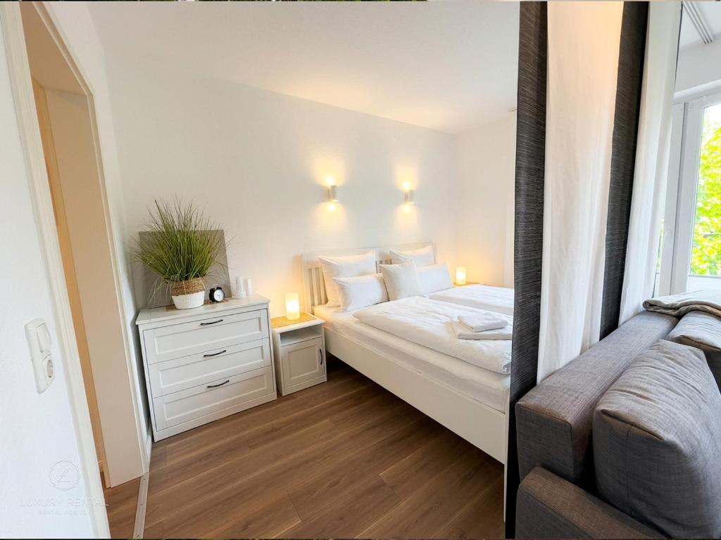 a small bedroom with a bed and a window at Apartment Etta im Dangaster Nest in Varel