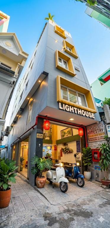 a scooter parked in front of a light house at Lighthouse Homestay Vũng Tàu in Vung Tau
