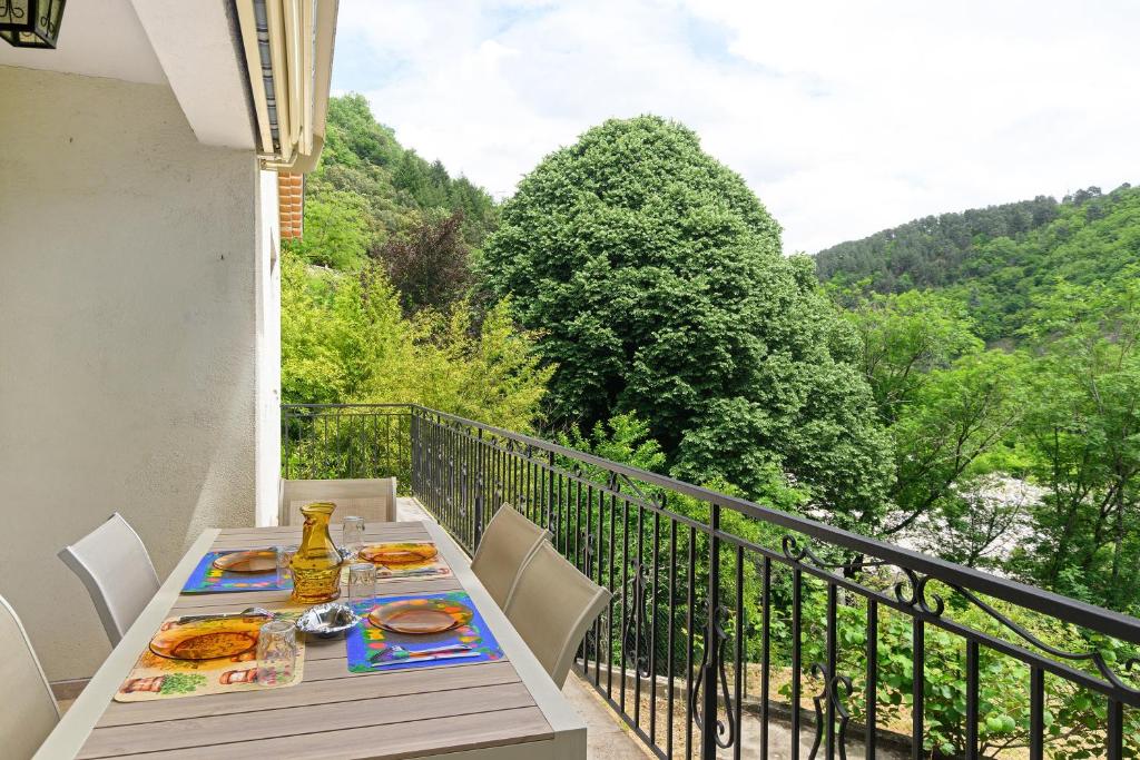 a table with plates of food on a balcony at La Clémenguite in Vals-les-Bains