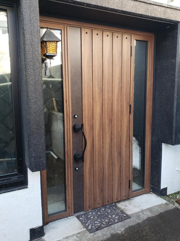 a wooden door to a house at Nozawa Onsen BASECAMP in Nozawa Onsen