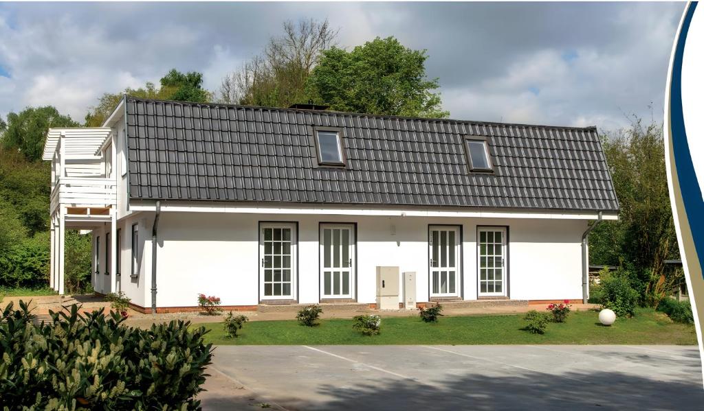 a white house with a black roof at Feriendomizil Putbus - Nr. 3c in Putbus