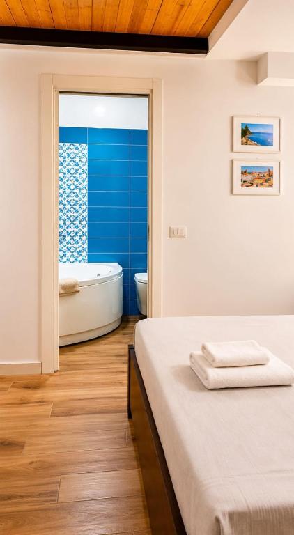 a bathroom with a tub and a bed and a bath tub at Rega Holiday House in Naples