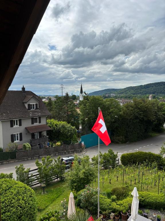 a red and white flag in front of a street at Dachstudio in Kaiseraugst