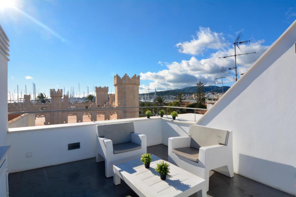 a balcony with two chairs and a table at Lonja Suites Apartments in Palma de Mallorca