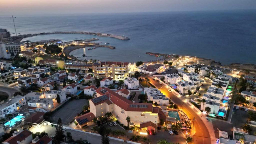an aerial view of a city at night at Anais Bay Hotel in Protaras
