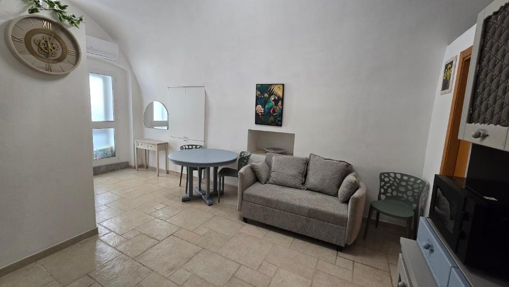 a living room with a couch and a table at Casa Alba in Bernalda