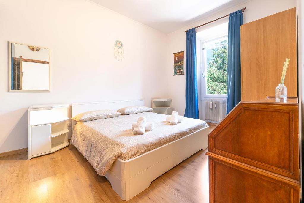 a bedroom with a bed with two teddy bears on it at Arco Park View By Immobilux in Arco