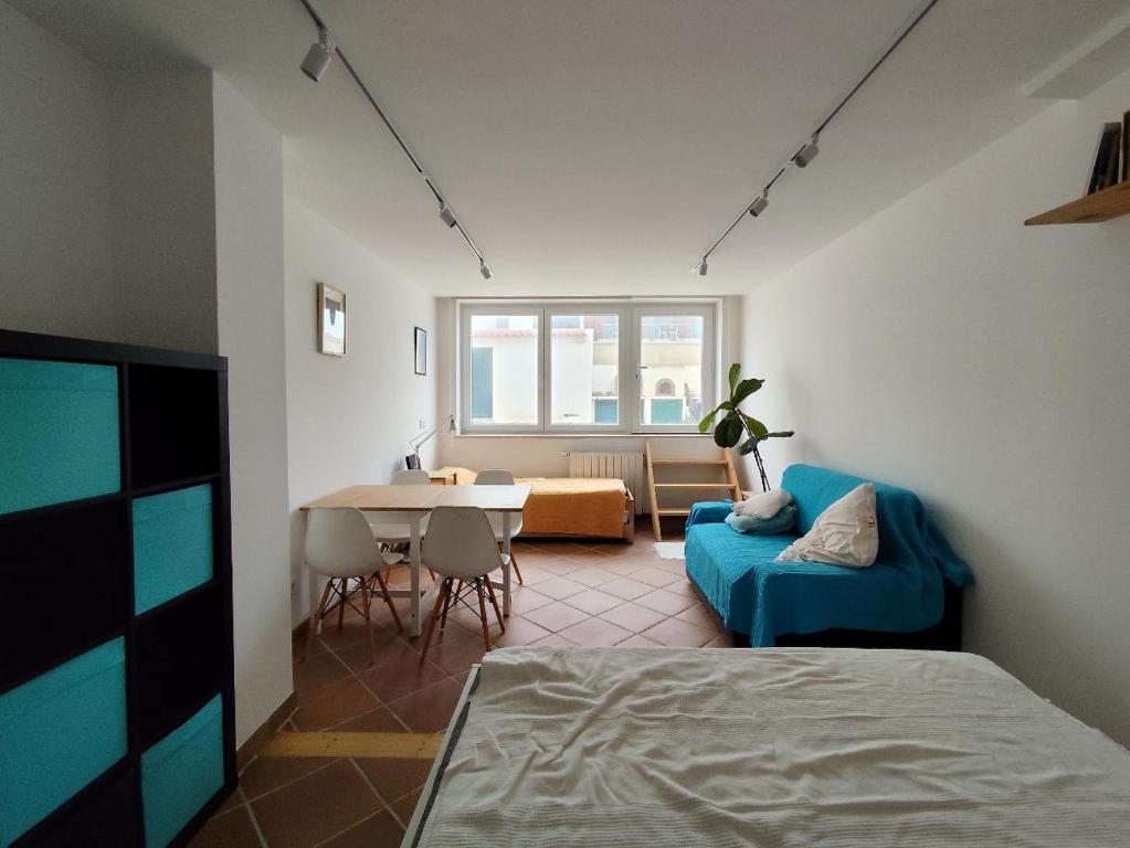 a living room with a blue couch and a table at Gigi Beachfront in Ferrel