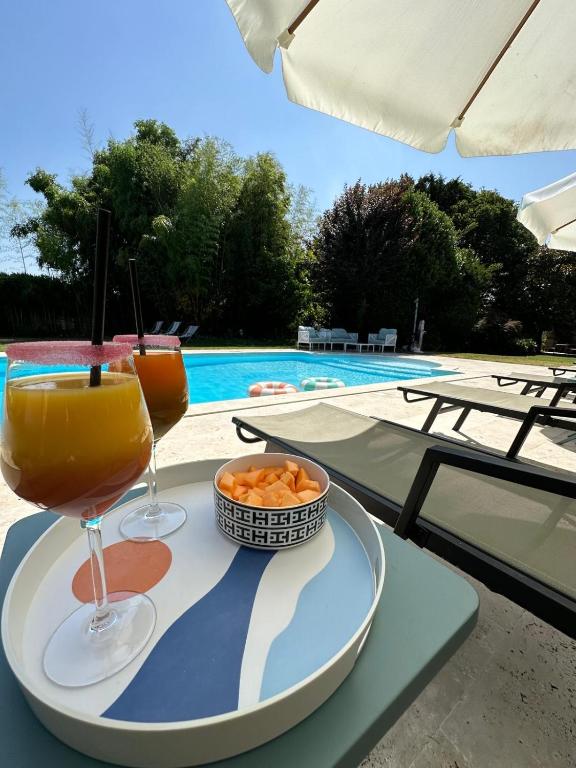 a table with two glasses of juice and a bowl of food at Le Clos Gabrielle in Châtellerault