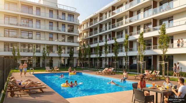 a group of people in a swimming pool in a building at Apartament BorMik, 150m od plaży, basen in Ustronie Morskie