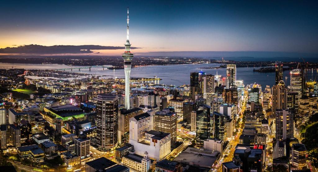a view of a city at night with the cn tower at Crowne Plaza Auckland by IHG in Auckland