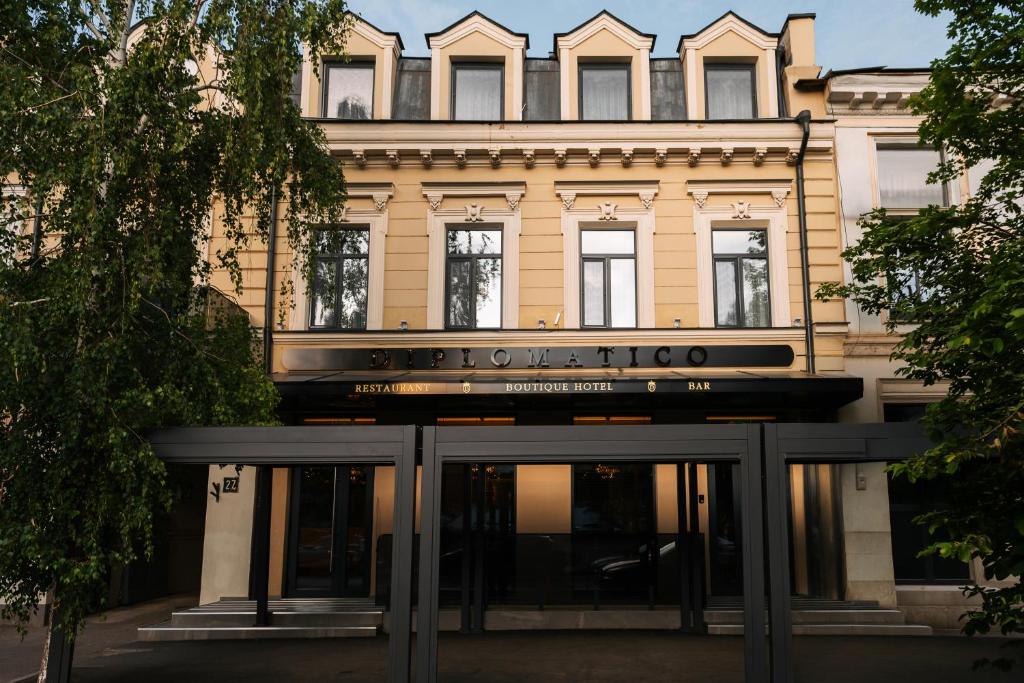 a building with a sign on the front of it at Diplomatico Hotel in Odesa